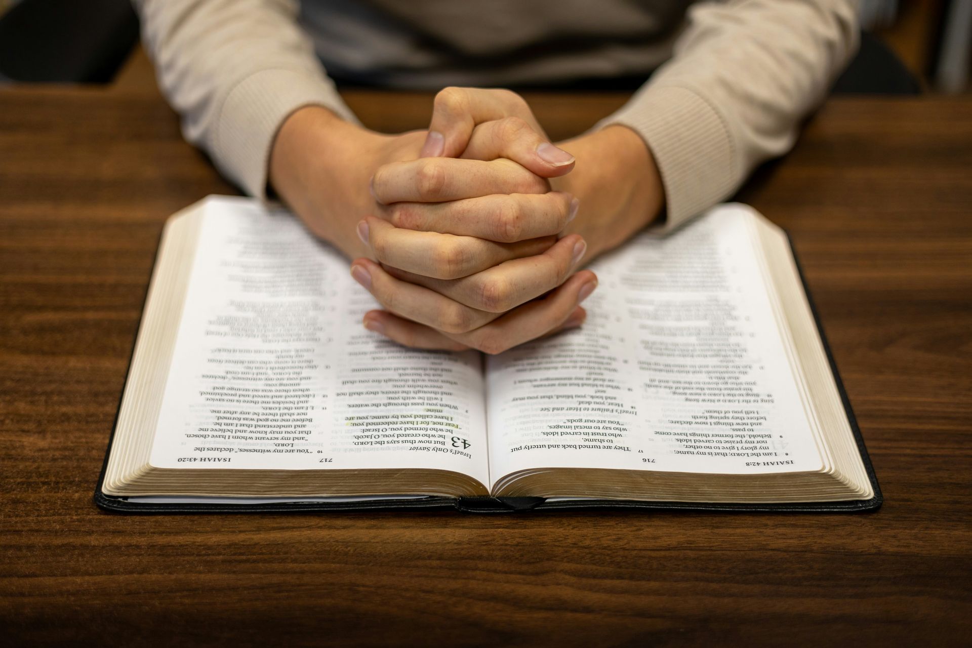 woman holding mug in front of bible
