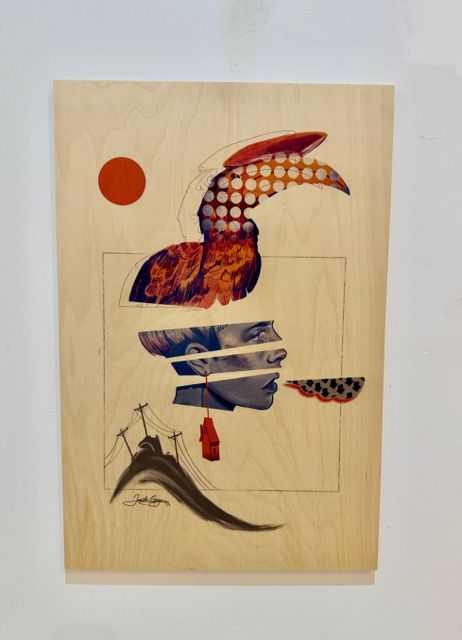 Surrealist mixed media on wood by Jane the Stranger — fragmented bird and female face collage with red sun, small hanging house, ink brushwork below