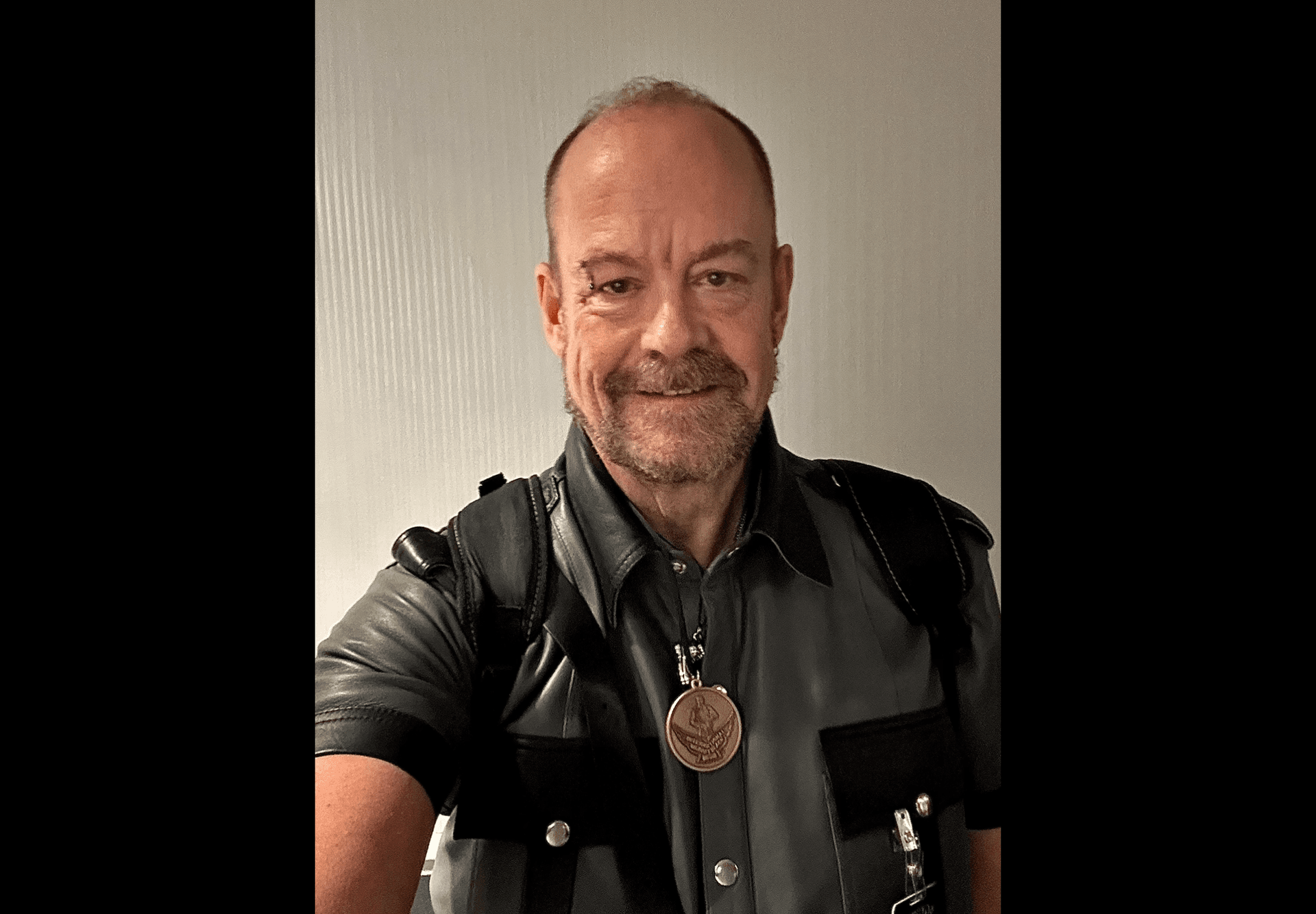 Scottie J wearing a black leather vest and IMLBB contestant medallion smiling in a selfie taken at the competition in Chicago Scottie J wearing a black leather vest and IMLBB contestant medallion smiling in a selfie taken at the competition in Chicago