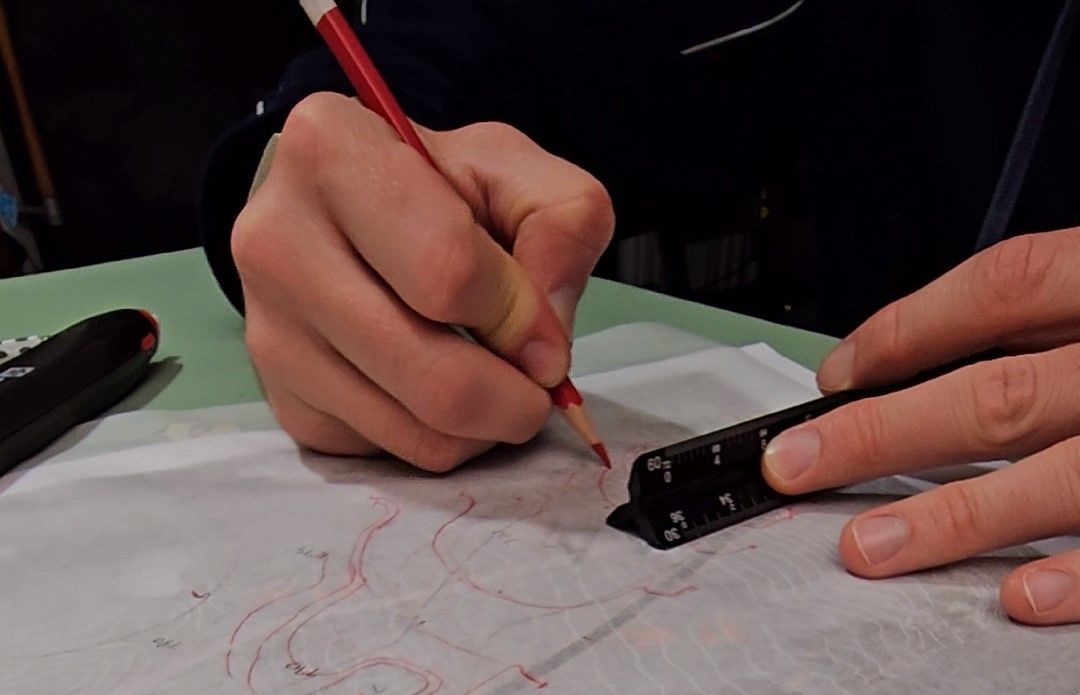 Hand drawing contours with a scale in hand using carmine red Prismacolor