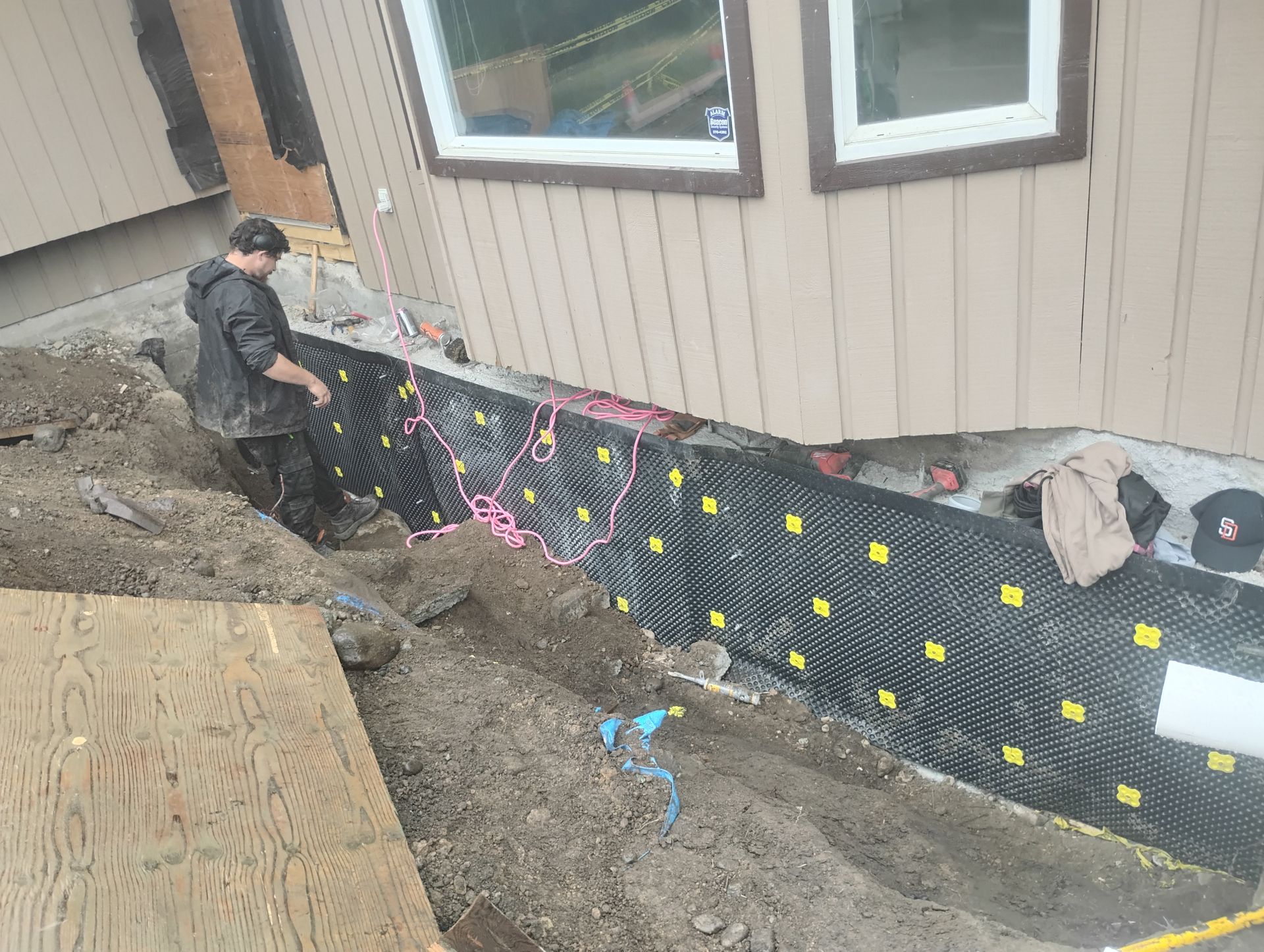 Foundation moisture barrier installed into place to protect the concrete supports from moisture-caused degradation. Foundation moisture barrier installed into place to protect the concrete supports from moisture-caused degradation.