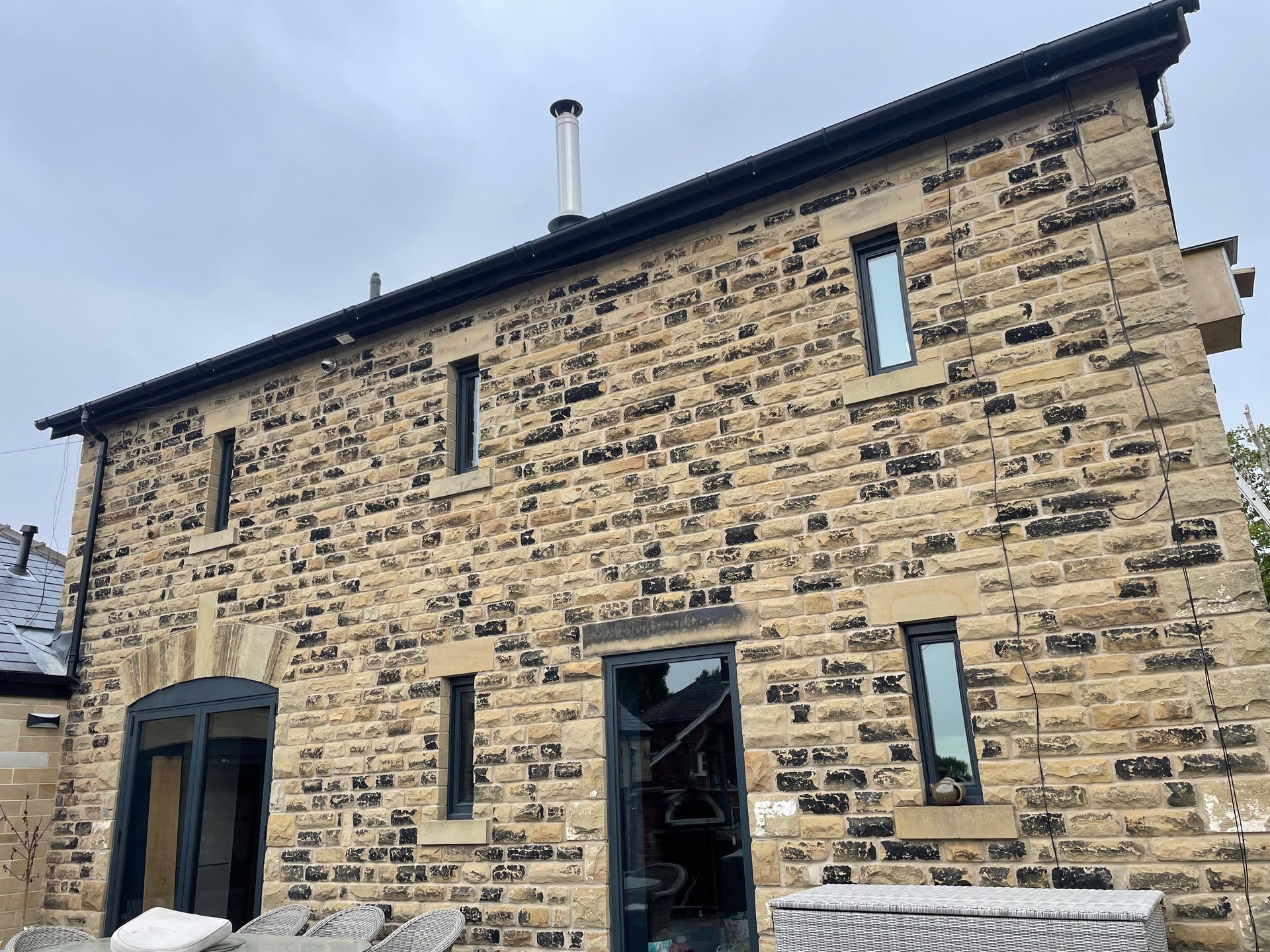 Rear of a peropty featuring 5 small windows and 1 patio door set, after traditional window cleaning in Pontefract WF8
