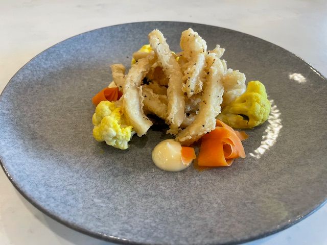 Lightly battered calamari dish from authentic Italian dinner menu at The Grid Café. Lightly battered calamari dish from authentic Italian dinner menu at The Grid Café.