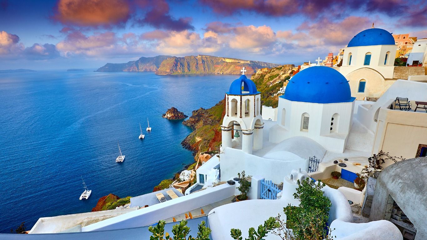 Blue-domed churches overlooking the Aegean Sea in Santorini.
