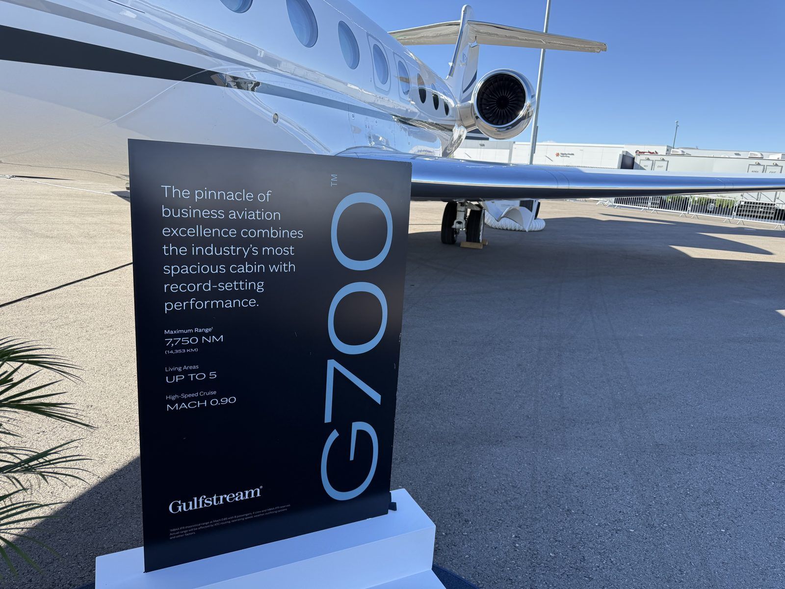Gulfstream G700 display sign listing 7,750 NM maximum range, up to 5 living areas, and Mach 0.90
