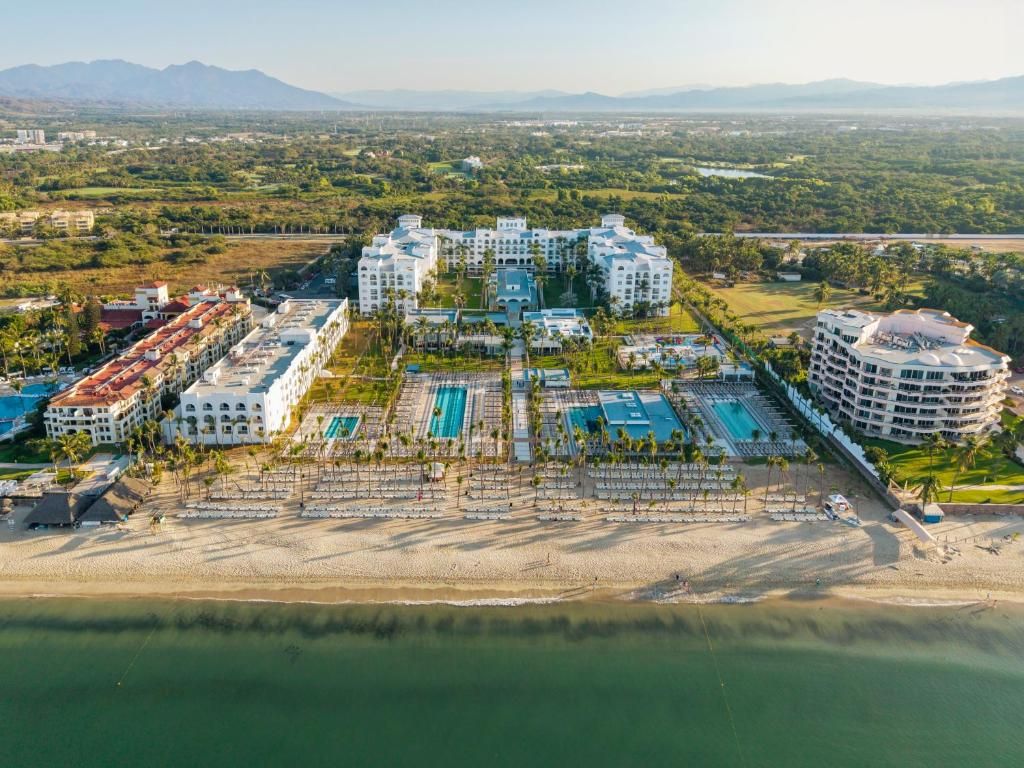 Aerial view of RIU Vallarta resort, pools, and beachfront Aerial view of RIU Vallarta resort, pools, and beachfront
