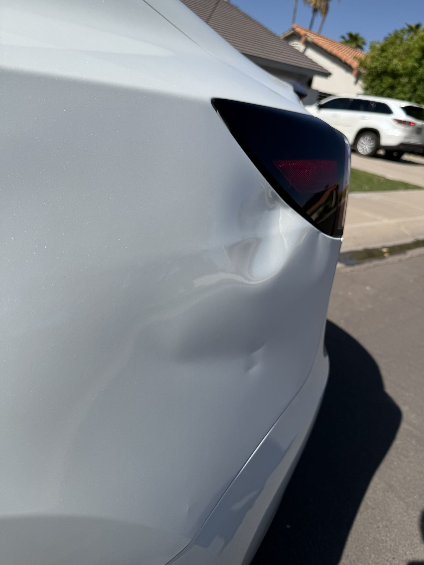 PresiDENTial Repair performing paintless dent repair on an electric vehicle