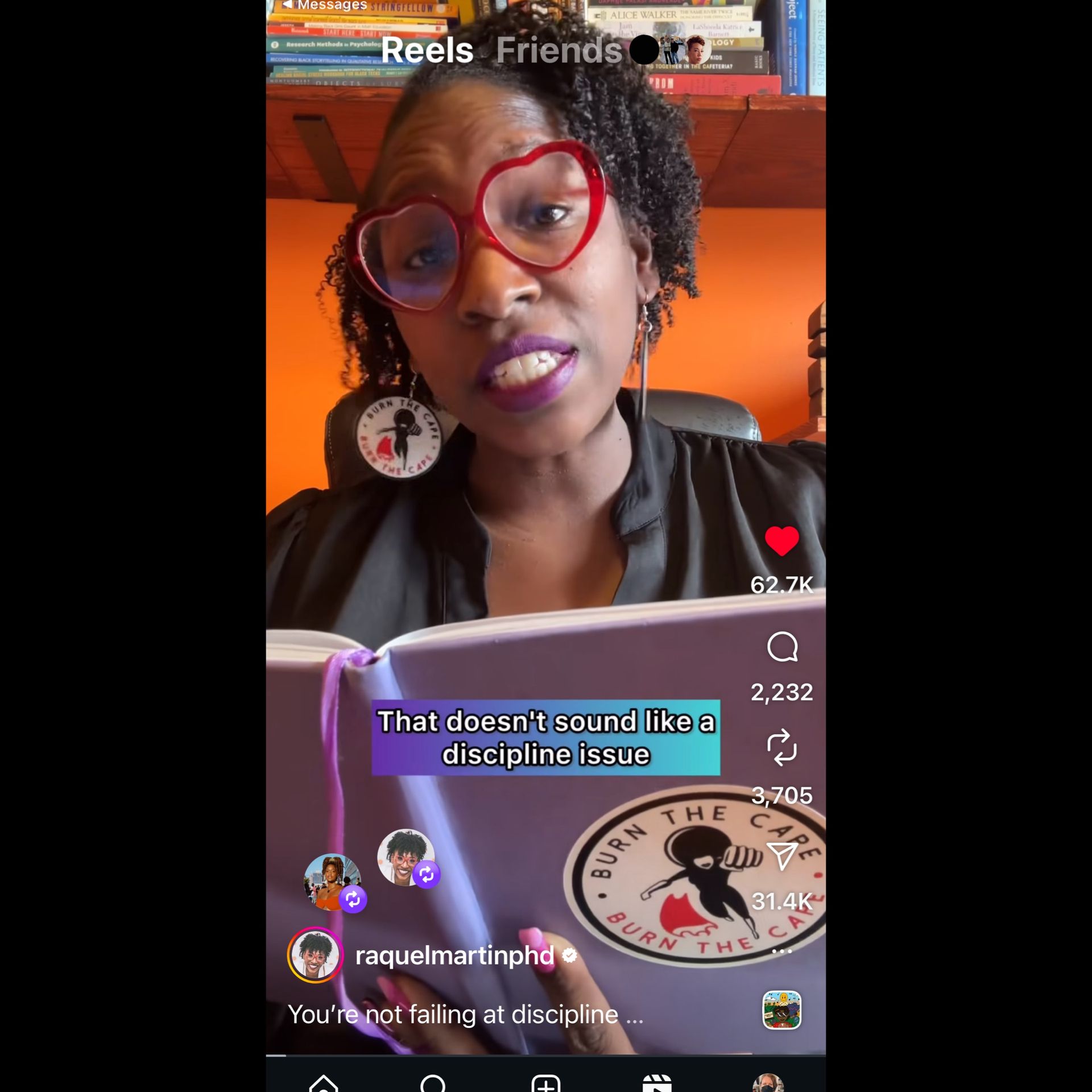 Dr Raquel Martin, PhD wearing red heart glasses and holding a notebook that says Burn the Cape is mid speech and the captions say That doesn't sound like a discipline issue.