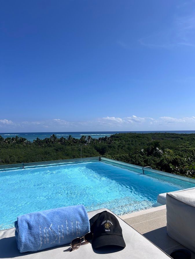 Rooftop pool view of Jashita Hotel on Soliman Bay with calm turquoise water and palm-lined shoreline