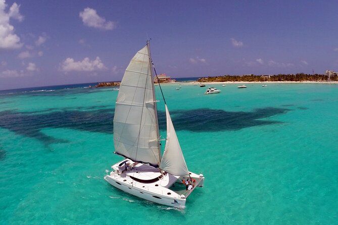 White catamaran sailing on turquoise Caribbean waters near Isla Mujeres