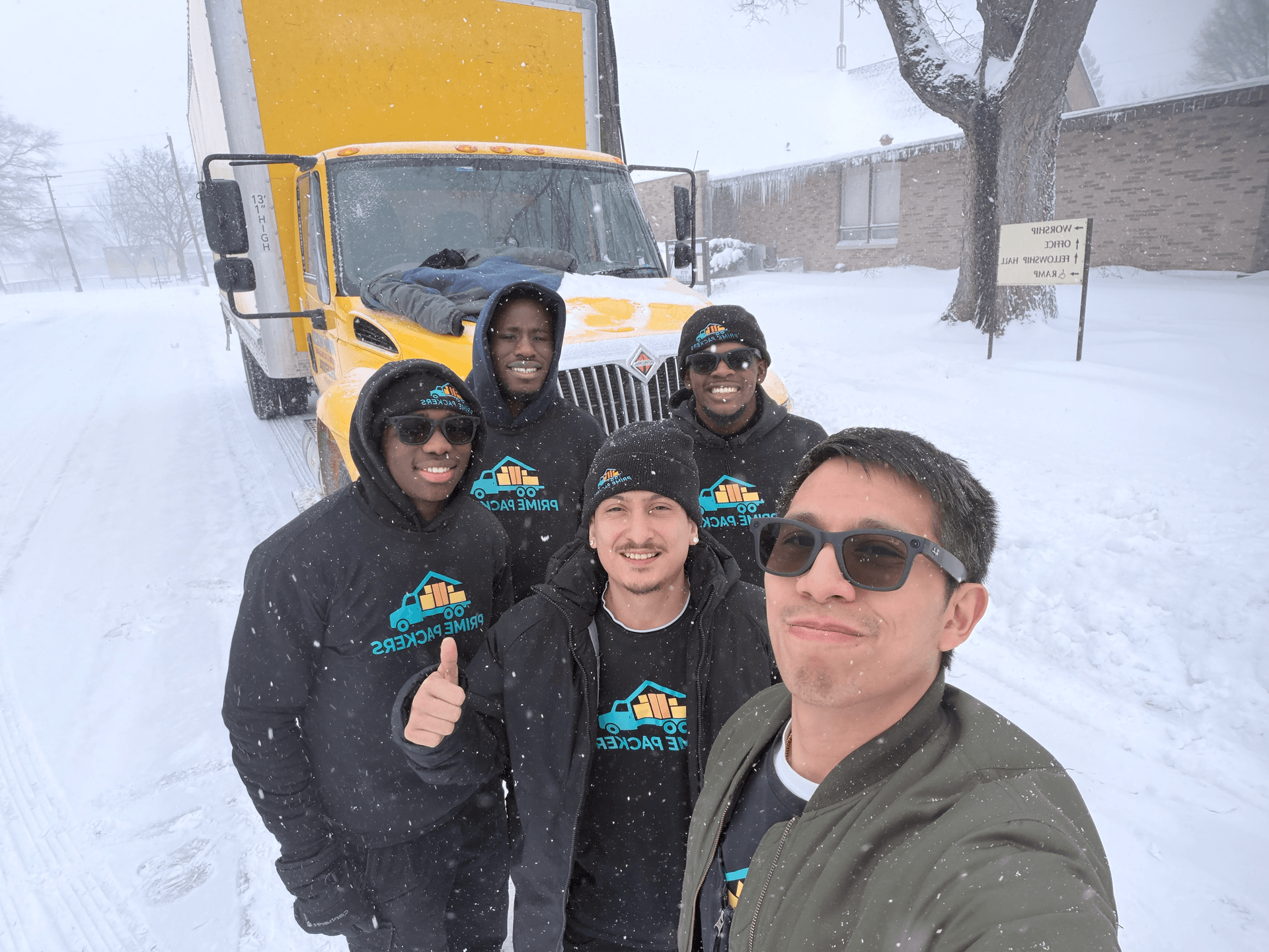 Prime Packers LLC moving crew in the snow with their truck in Berrien Springs, Michigan
