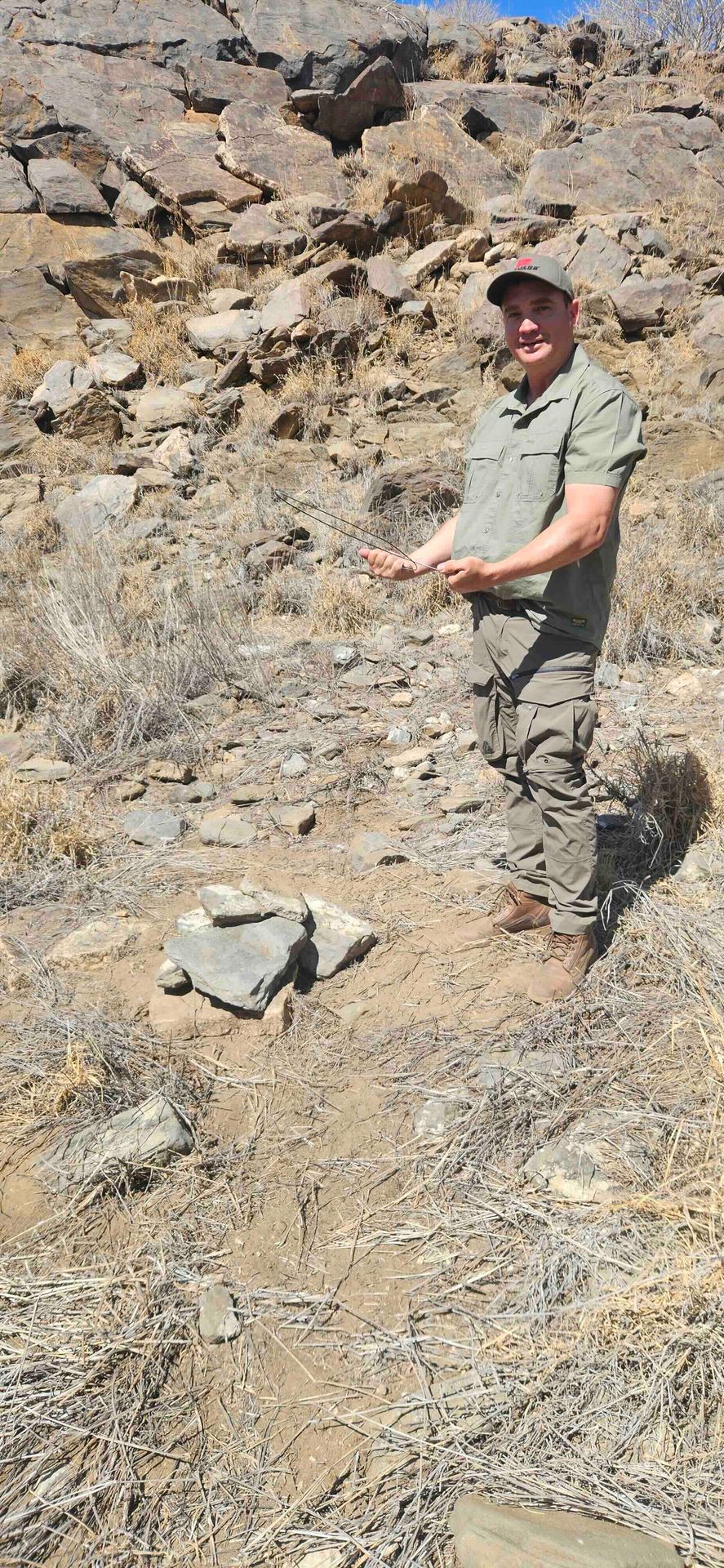 Bernd with the divining rods over the stone marker