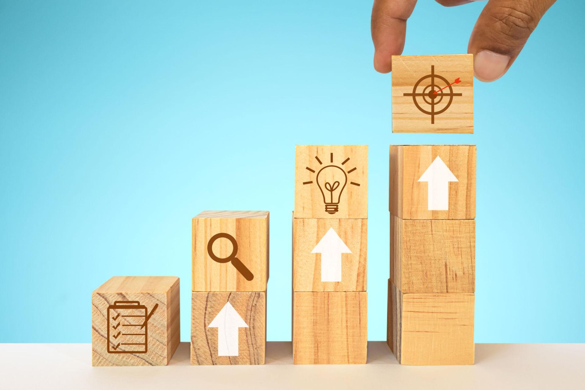 Wooden planning blocks arranged in sequence to illustrate a business technology roadmap. Wooden planning blocks arranged in sequence to illustrate a business technology roadmap.