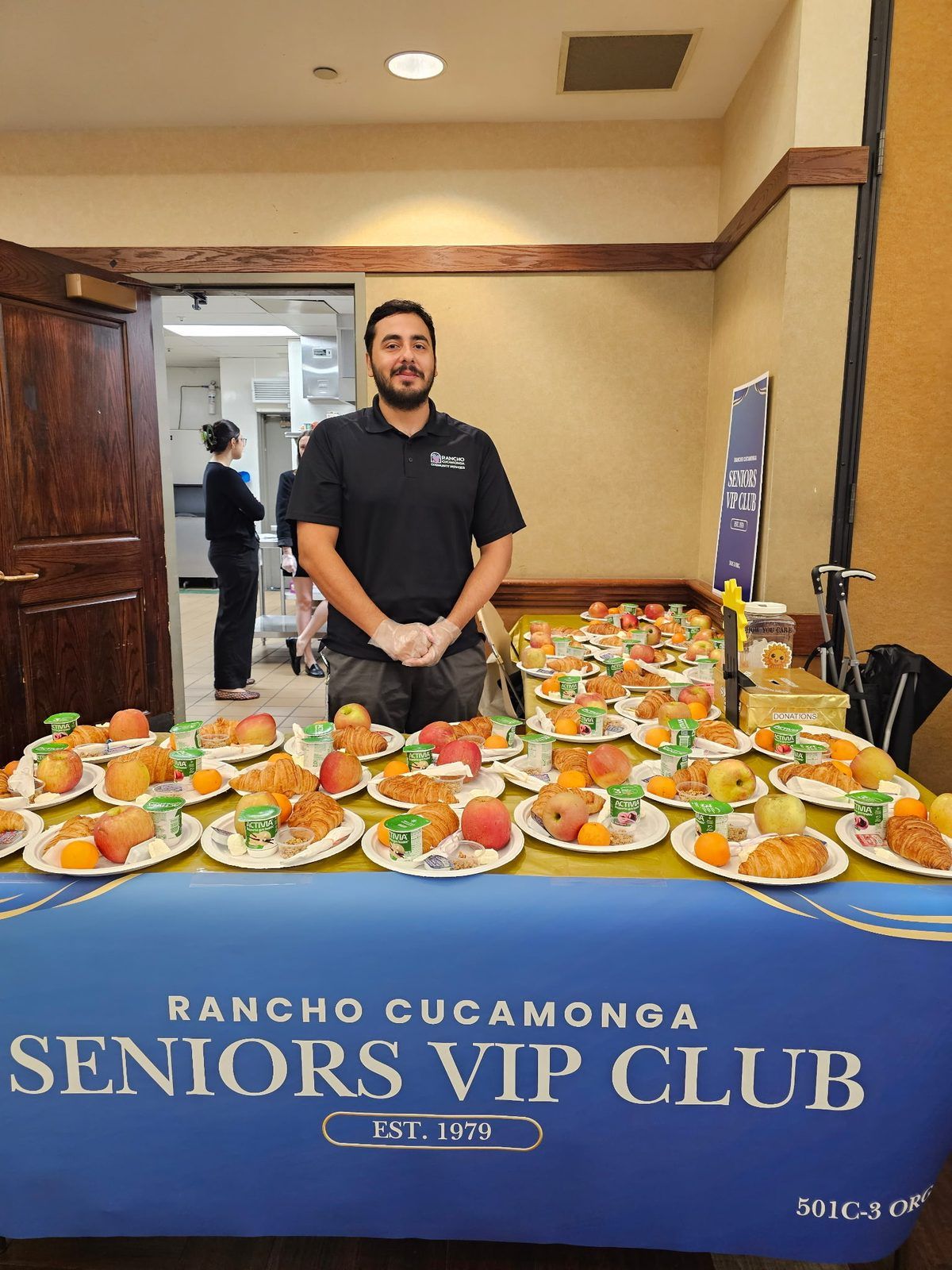 Breakfast plates of fresh fruit and pastries under the Seniors VIP Club banner Breakfast plates of fresh fruit and pastries under the Seniors VIP Club banner