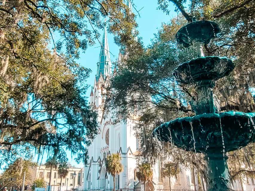 Historic fountain in front of a charming church in Savannah, surrounded by Southern greenery. Historic fountain in front of a charming church in Savannah, surrounded by Southern greenery.