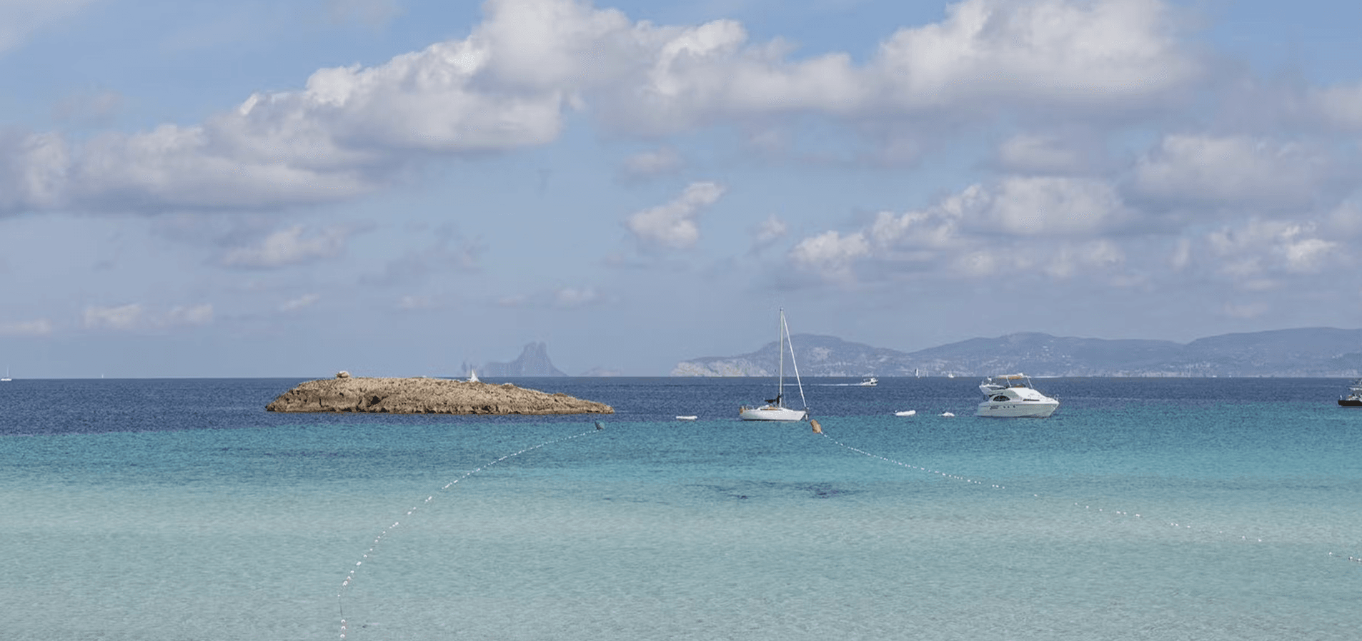 “Sunny summer day at Ses Illetes beach Formentera 2025 with crystal clear turquoise wate