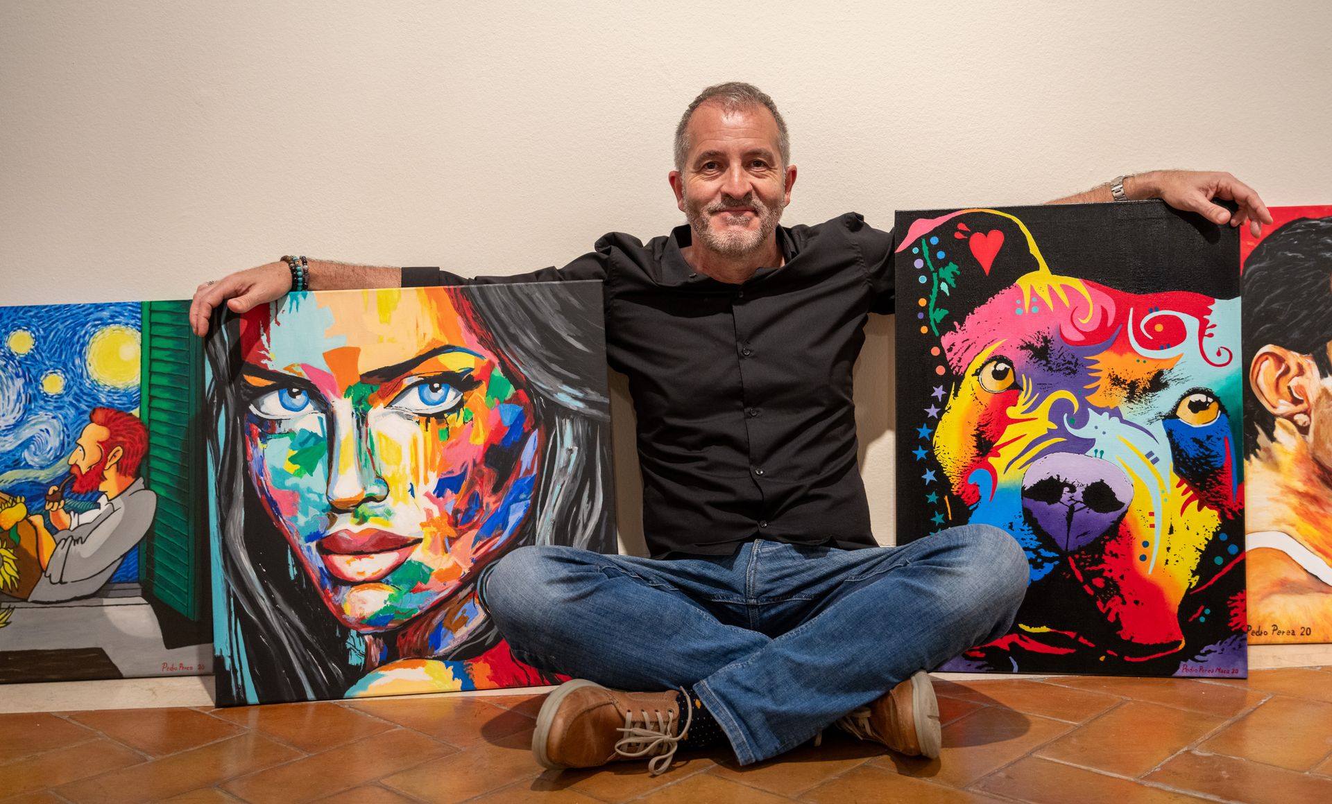 Portrait of an artist painting on easel. Shot in workshop
