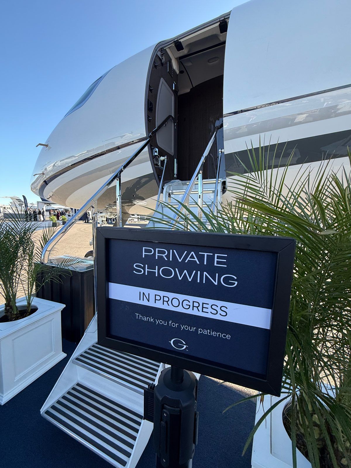 Gulfstream airstair with a Private Showing In Progress sign at the foot of the stairs