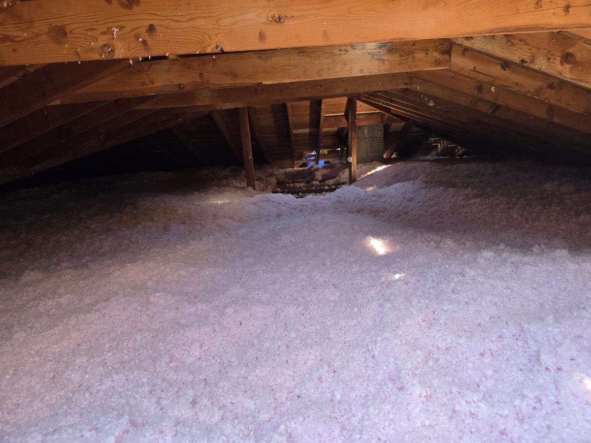 Finished attic with new pink AttiCat insulation by MichConn