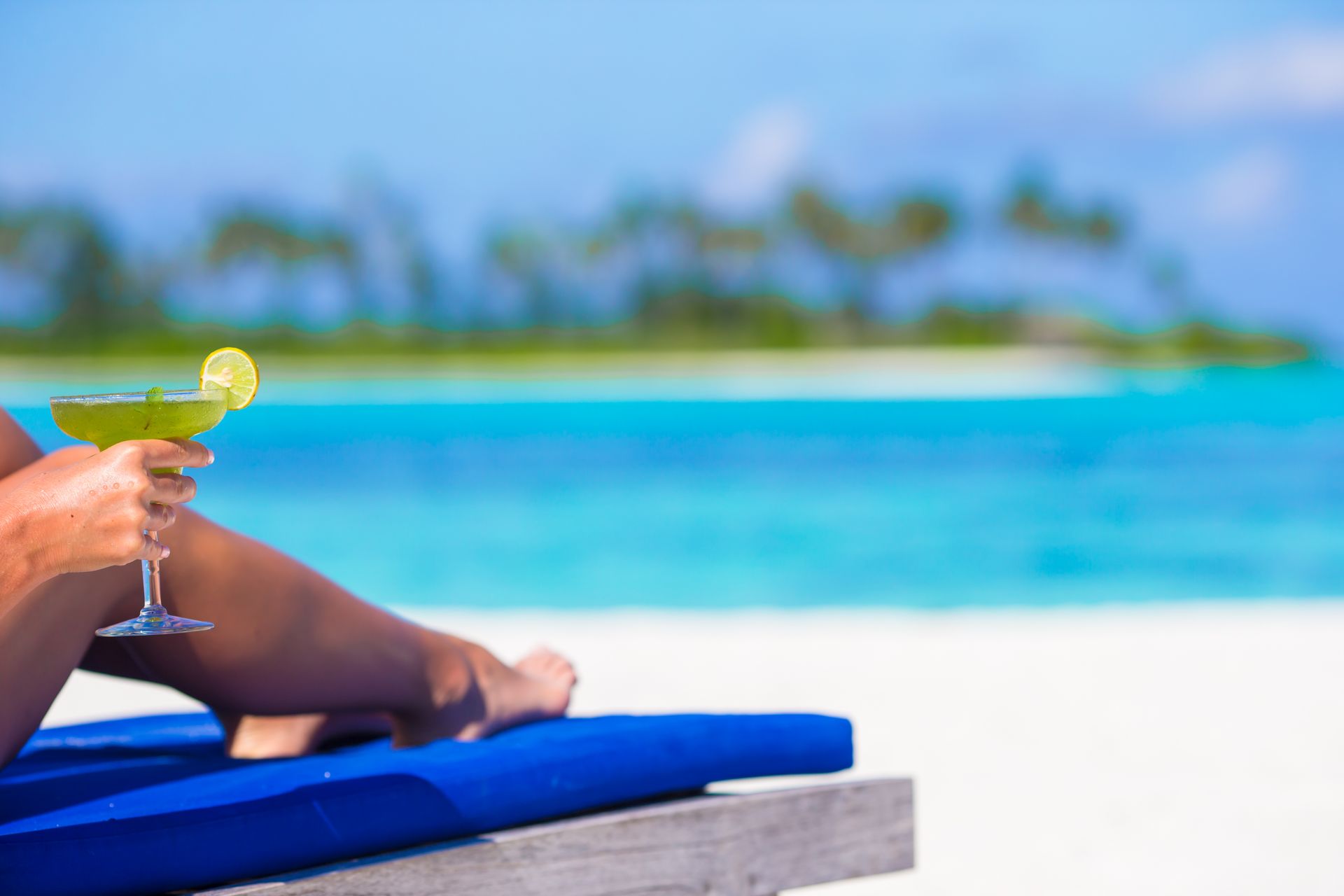 Relaxing on the beach with a margarita cocktail