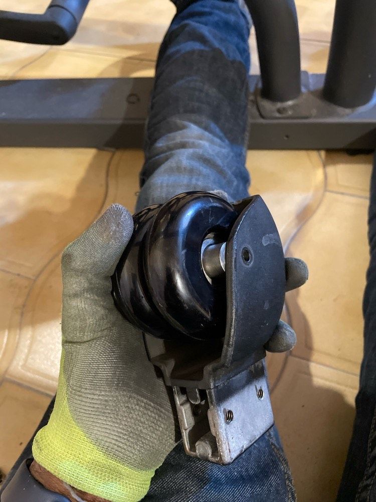 Senior Woman Doing Resistance Band Shoulder Exercise With Female Trainer In Gym Rehabilitation Session