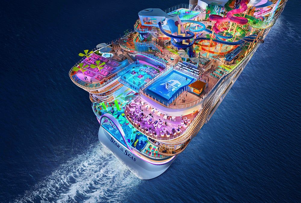 Aerial view of a brightly lit cruise ship sailing at night, featuring water slides, pools, lounges, and vibrant activity areas across multiple open decks. Aerial view of a brightly lit cruise ship sailing at night, featuring water slides, pools, lounges, and vibrant activity areas across multiple open decks.
