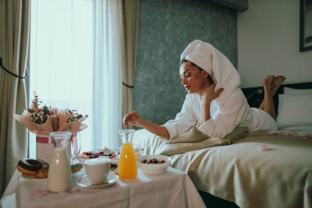 Hotel room setting with a neatly made bed, soft lighting, and a cozy atmosphere—designed to illustrate a relaxed, luxurious space perfect for enjoying afternoon room service. Hotel room setting with a neatly made bed, soft lighting, and a cozy atmosphere—designed to illustrate a relaxed, luxurious space perfect for enjoying afternoon room service.