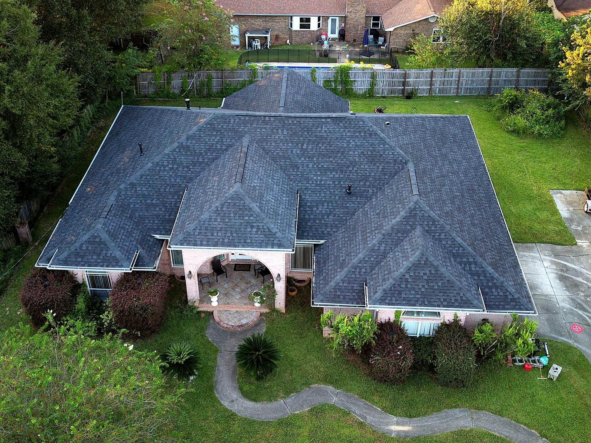 Finished charcoal architectural shingle hip roof on a brick home, completed by P3