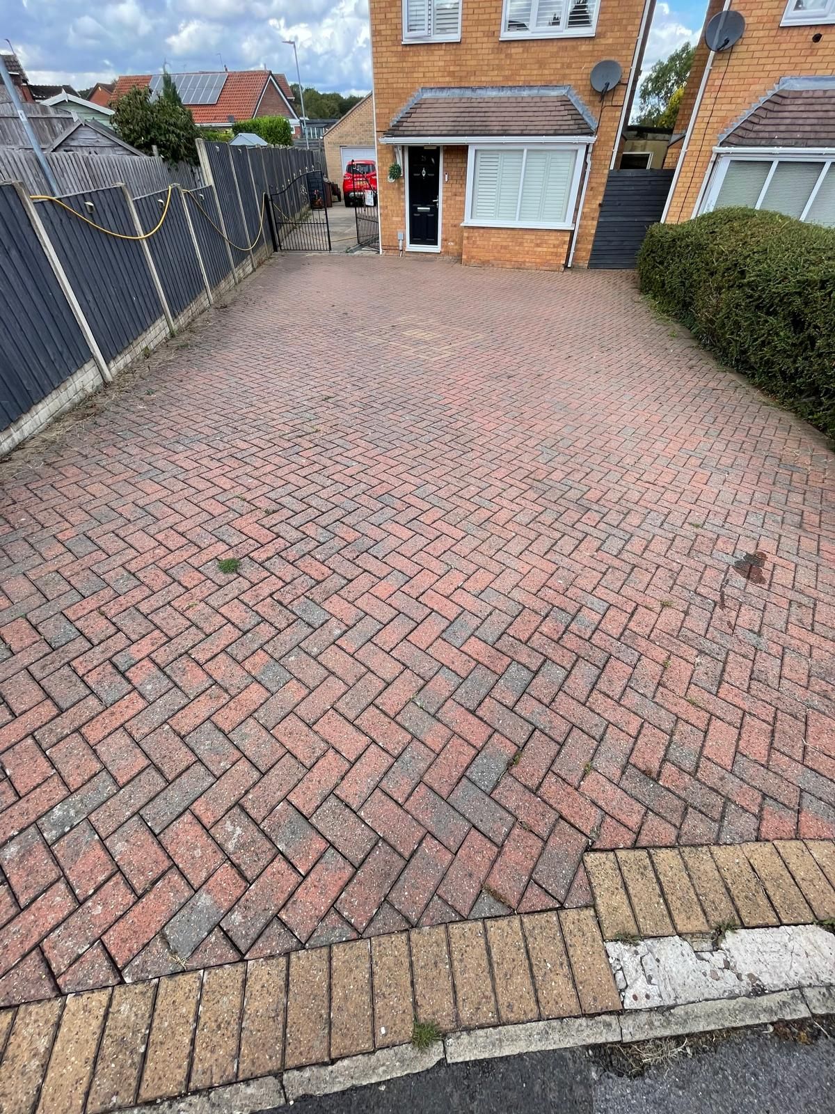 Dirty Driveway with weeds forming around the edges!