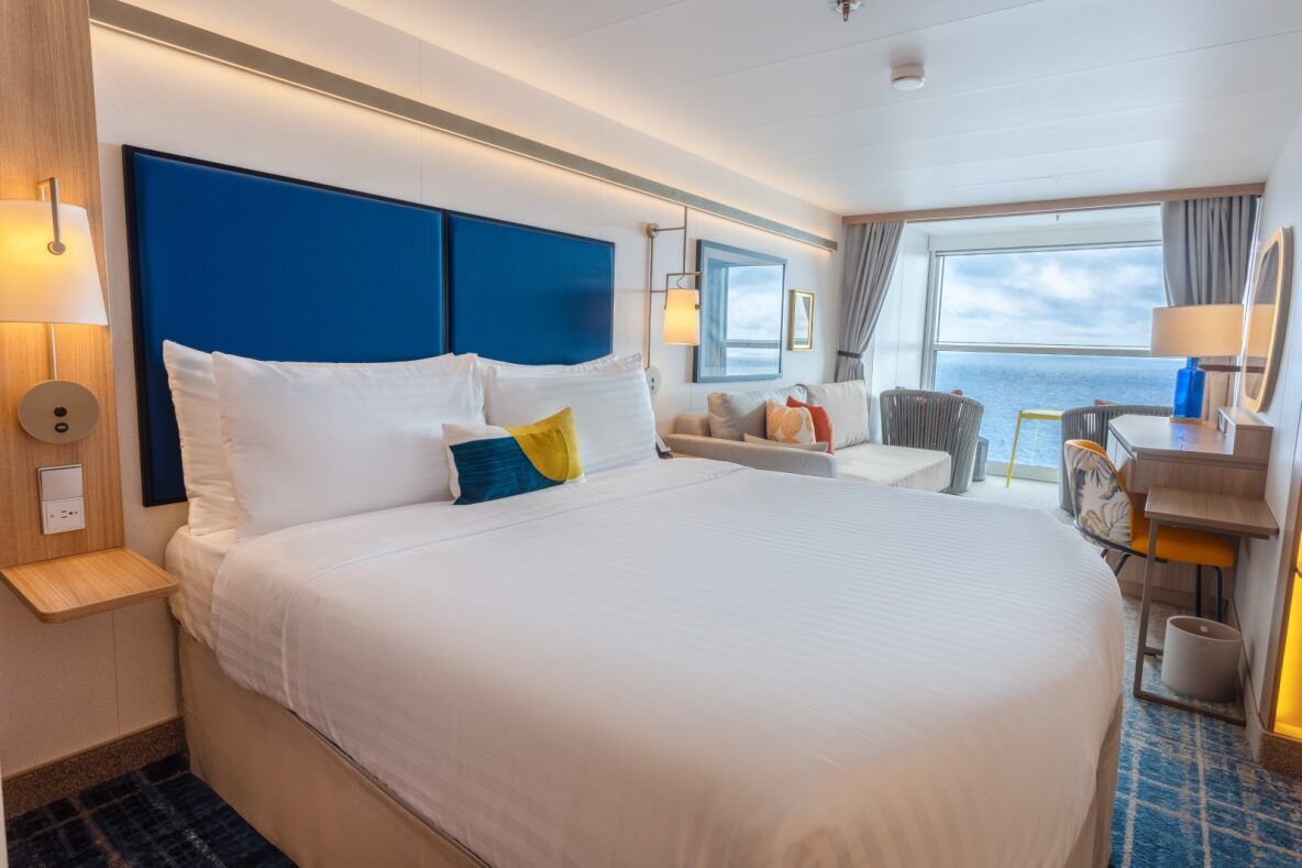 Bright, airy staterooms featuring plush beds, oceanfront balconies, and chic decor.