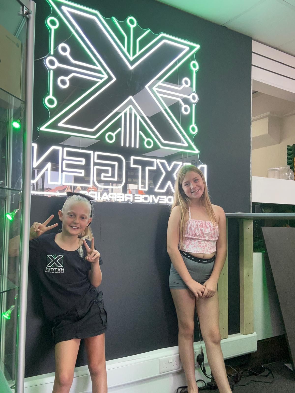 picture of owners family next to nxt gen logo at the shop picture of owners family next to nxt gen logo at the shop