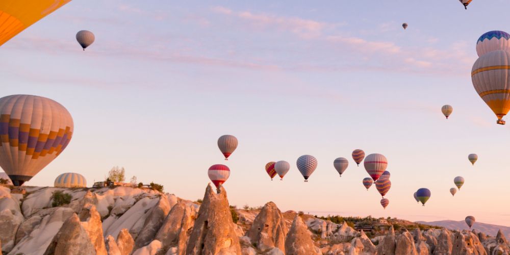 Colorful hot air balloons float over Cappadocia at sunrise. Colorful hot air balloons float over Cappadocia at sunrise.