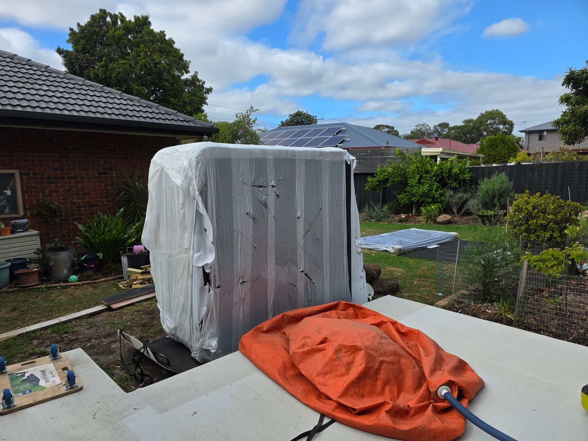 Luxury outdoor hot tub and swimming pool with serene blue tiles surrounded by lush garden greenery and modern villa elements in a tropical resort setting on a bright sunny day.