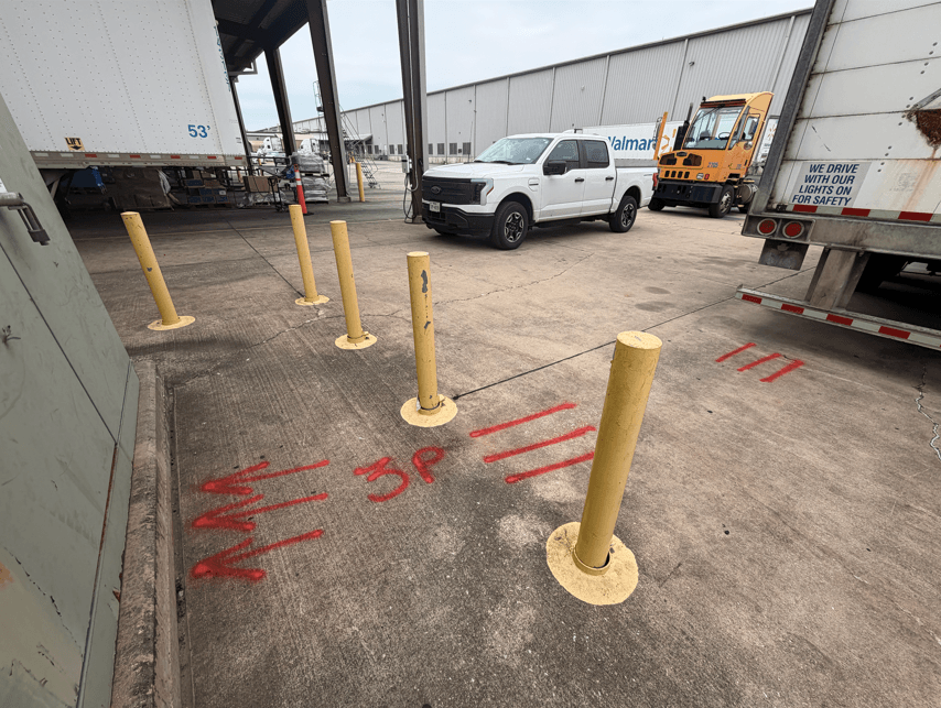 Private utility locating markings near loading dock access at a Walmart distribution center in Sealy, TX