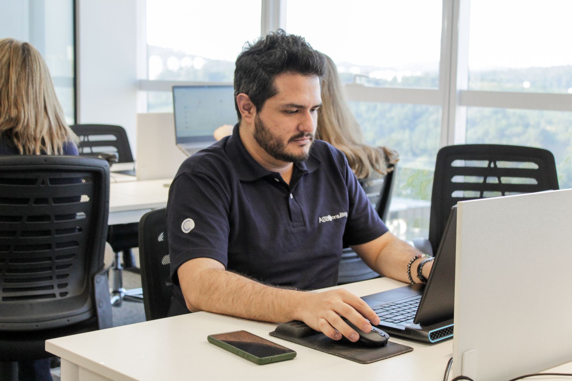Young male professional working at a working station on his laptop