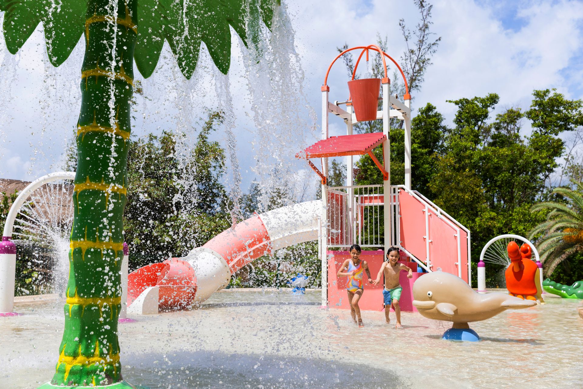 Two children run through a colorful waterpark with slides, spraying fountains, and playful animal sculptures under the sun. Two children run through a colorful waterpark with slides, spraying fountains, and playful animal sculptures under the sun.