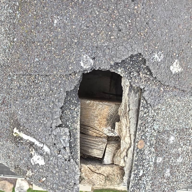 Hole through the roof edge, wood showing