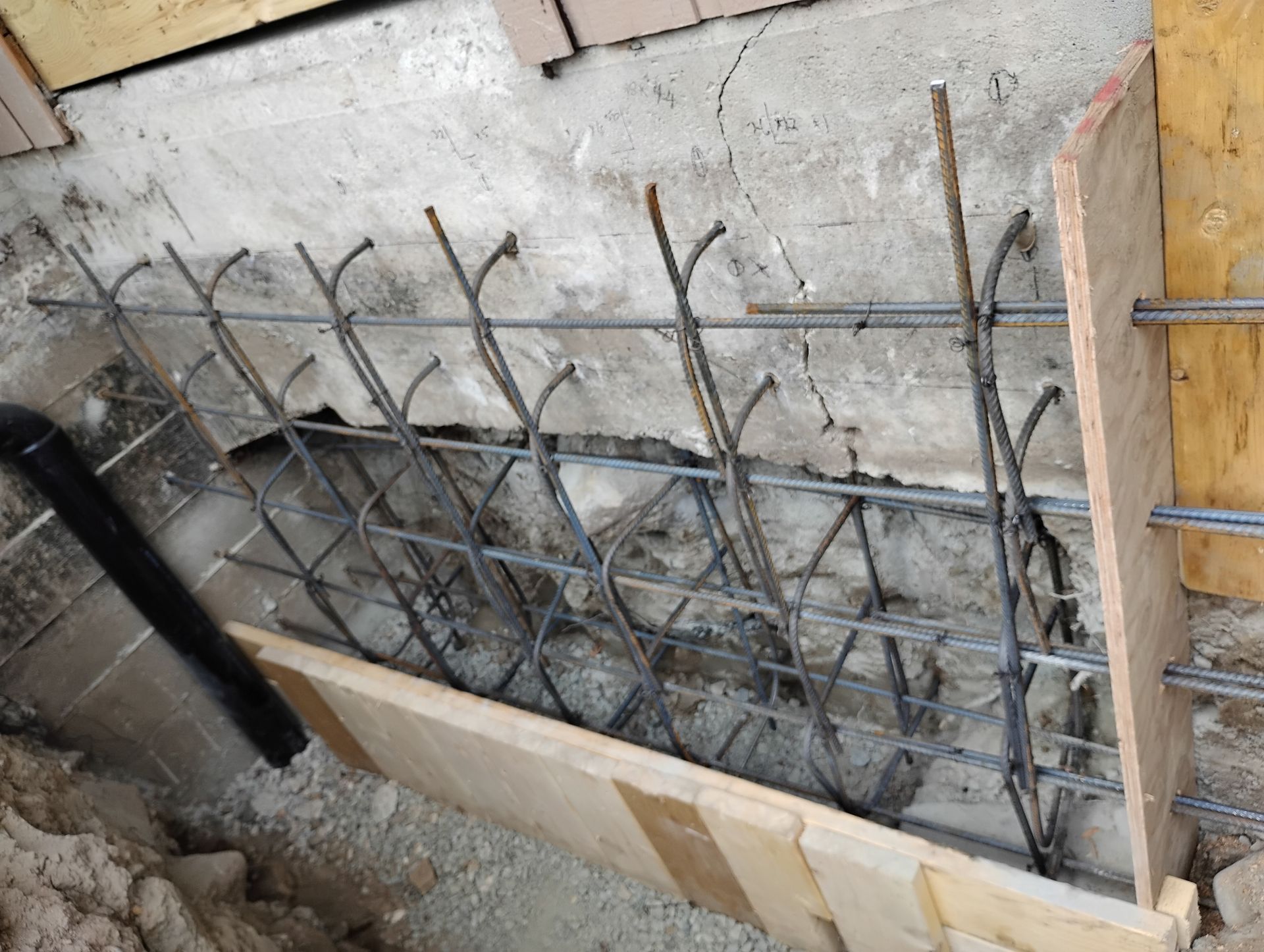 Formwork and heavy-duty steel rebar reinforcement in place to permanently stabilize the shifting concrete wall. Formwork and heavy-duty steel rebar reinforcement in place to permanently stabilize the shifting concrete wall.