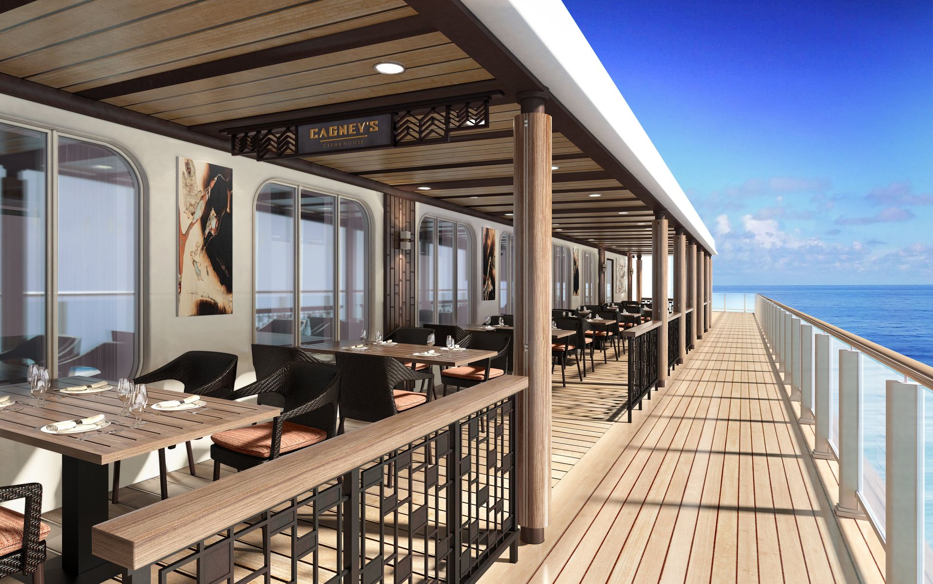 Outdoor waterfront steakhouse dining area on a cruise ship with tables set along the deck, overlooking the open ocean under a clear blue sky.