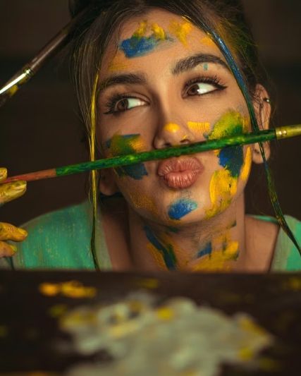 People are painting outdoors at an art event.