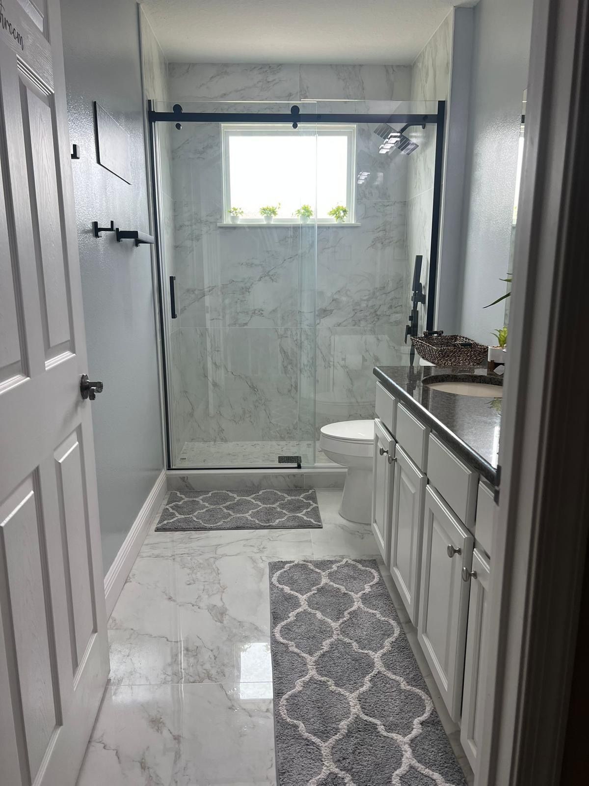 Modern guest bathroom remodel in Orlando with walk-in shower and wood vanity Modern guest bathroom remodel in Orlando with walk-in shower and wood vanity
