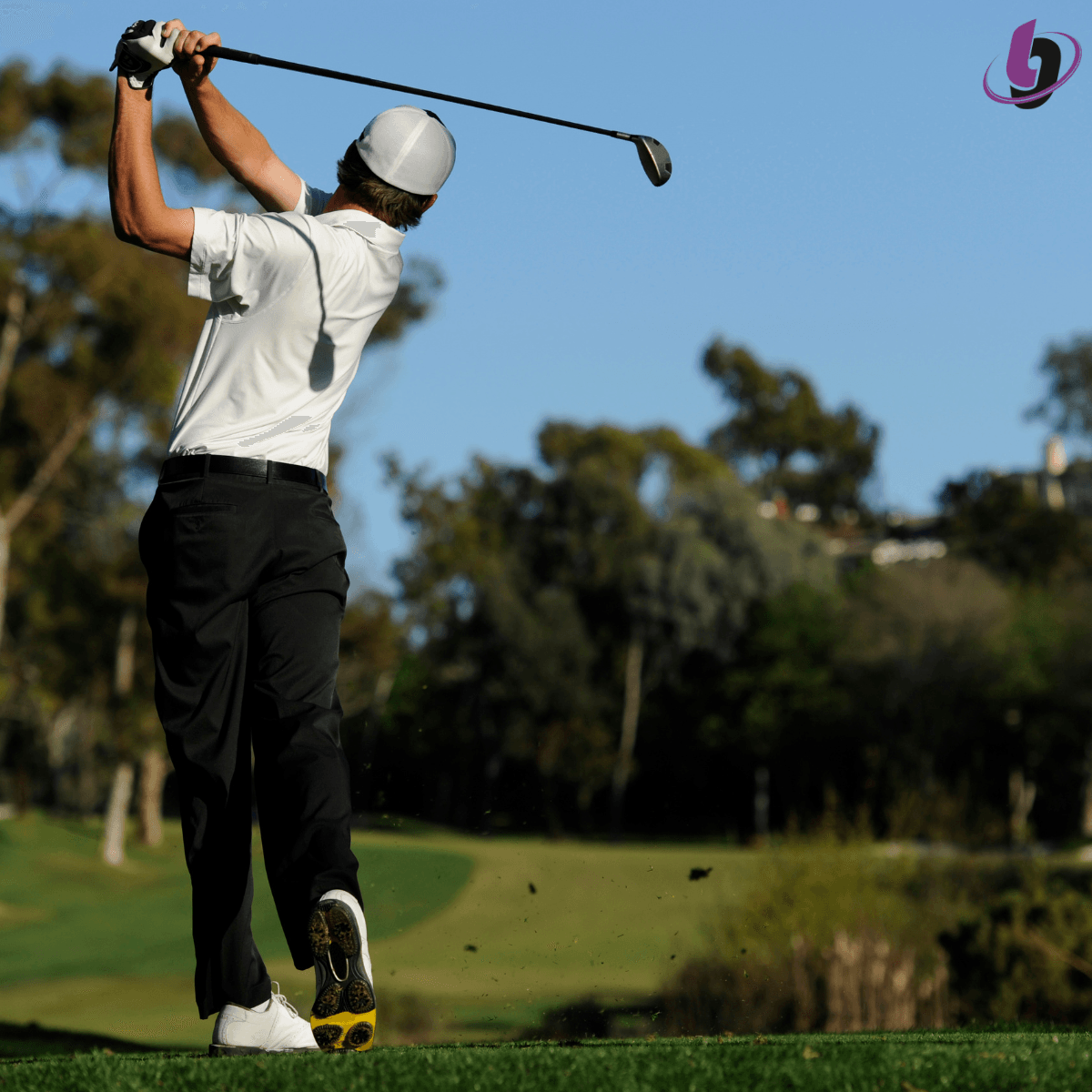 Golfer finishing swing with strong posture and balance demonstrating controlled power Golfer finishing swing with strong posture and balance demonstrating controlled power