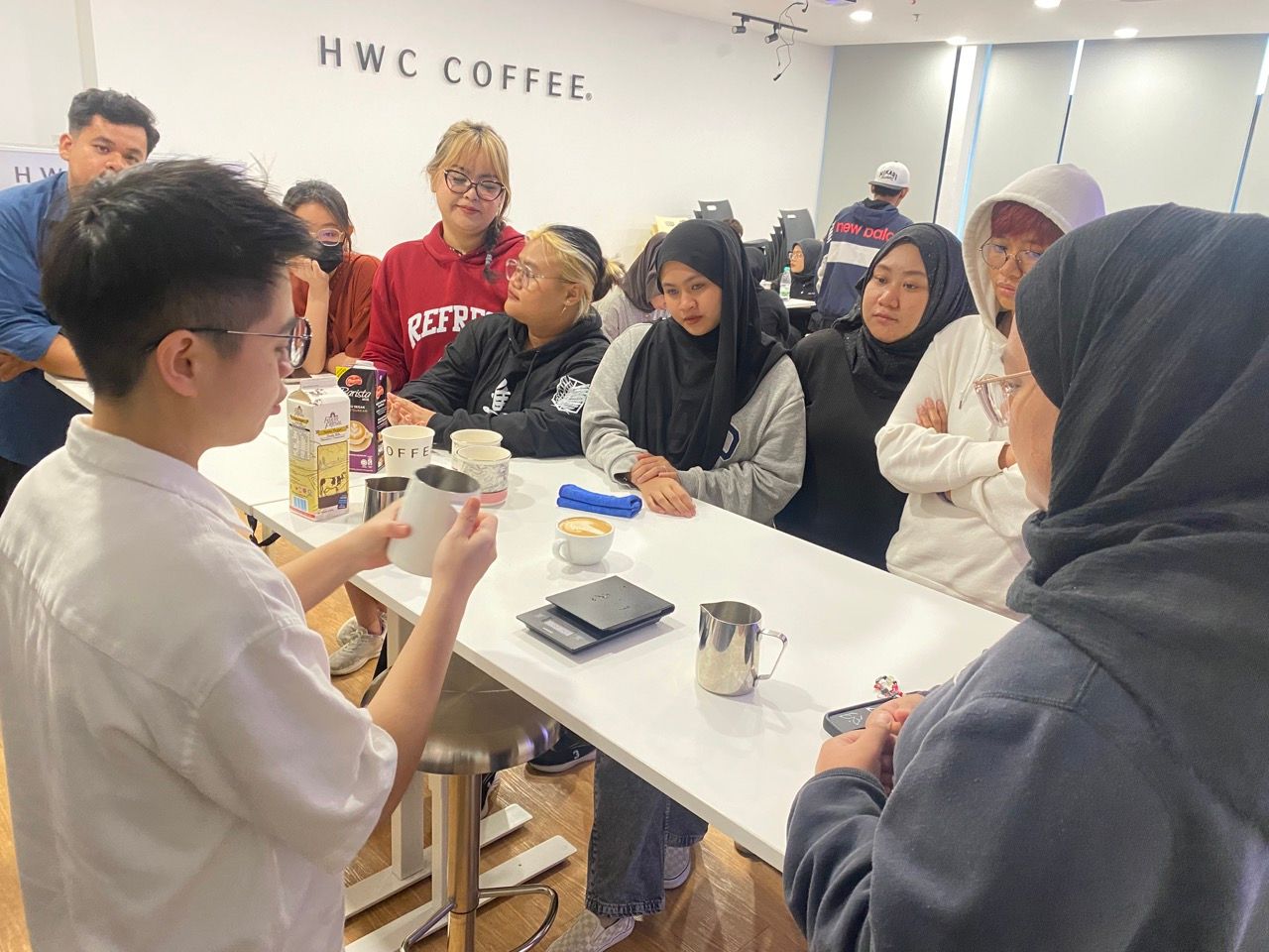 Instructor teaching advanced latte art to SKM barista trainees at CAN Academy CoffeeHub Kuala Lumpur