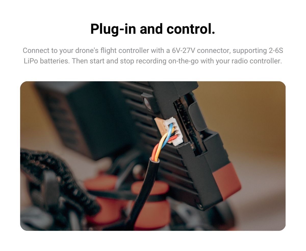 Hand holding fpv racing drone on blue background. Starting motors