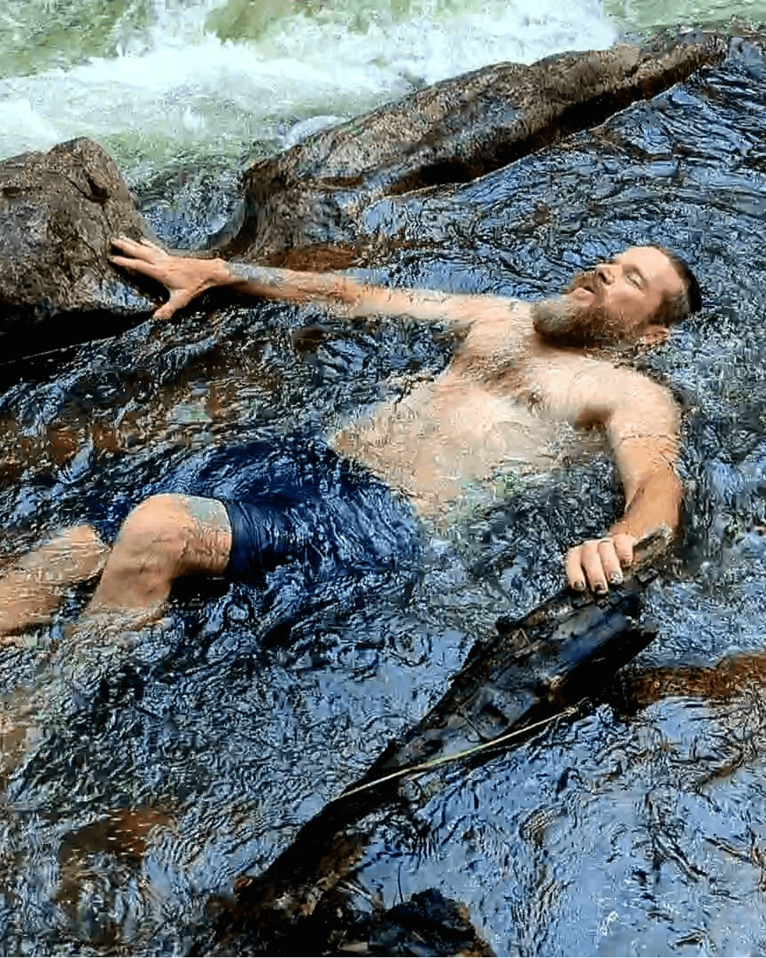 Man practicing breathwork while reclining in an ice bath, illustrating nervous system regulation and building capacity to handle stress. Man practicing breathwork while reclining in an ice bath, illustrating nervous system regulation and building capacity to handle stress.