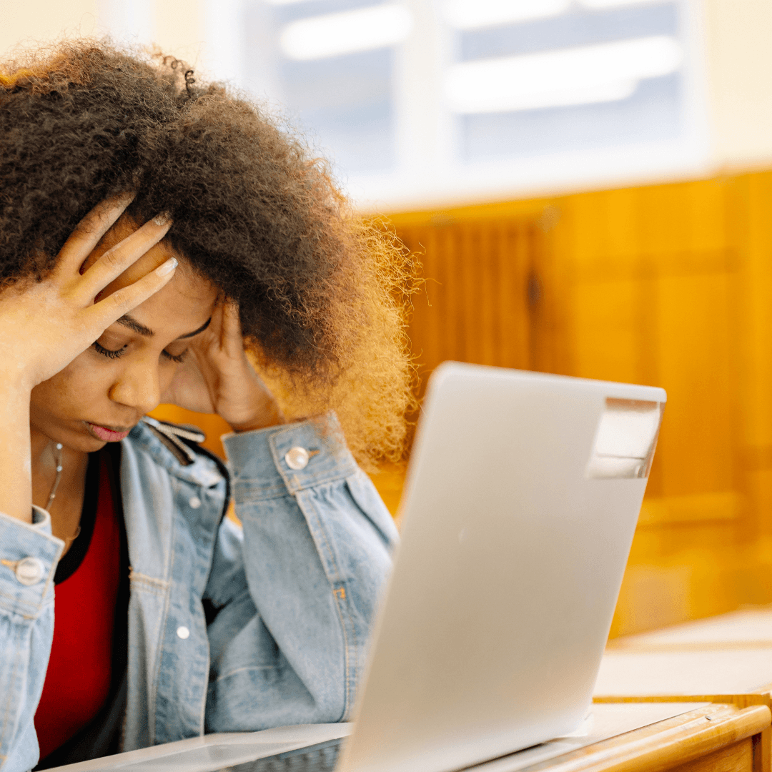 Overwhelmed female in front of her laptop - Planning a holiday online with multiple booking options and travel research