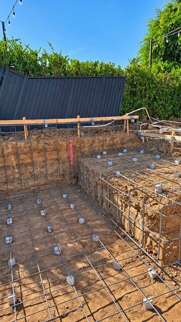 Rebar grid along excavated pool floor, wall and raised shelf