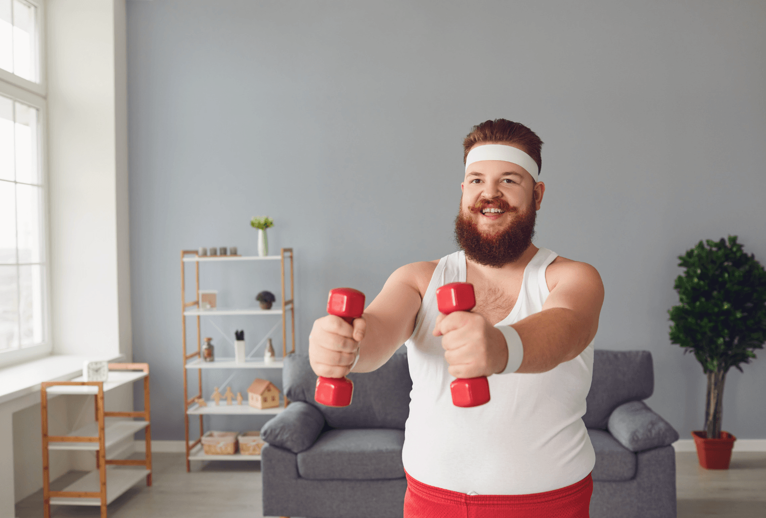 Mid adult man talking to instructor on exercise bike at gym Mid adult man talking to instructor on exercise bike at gym