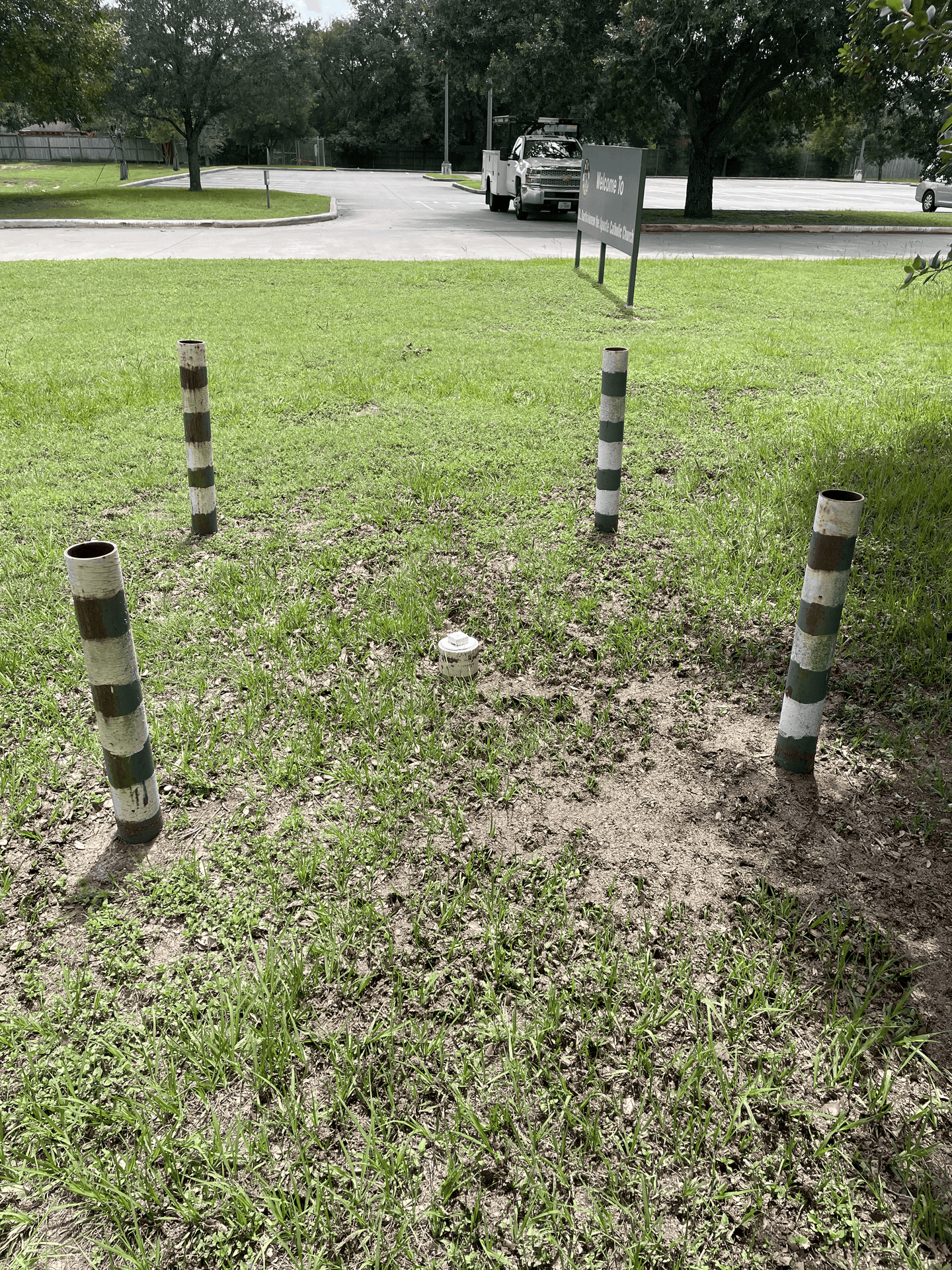 Private utility locating paint marks and marker flags on a Houston property