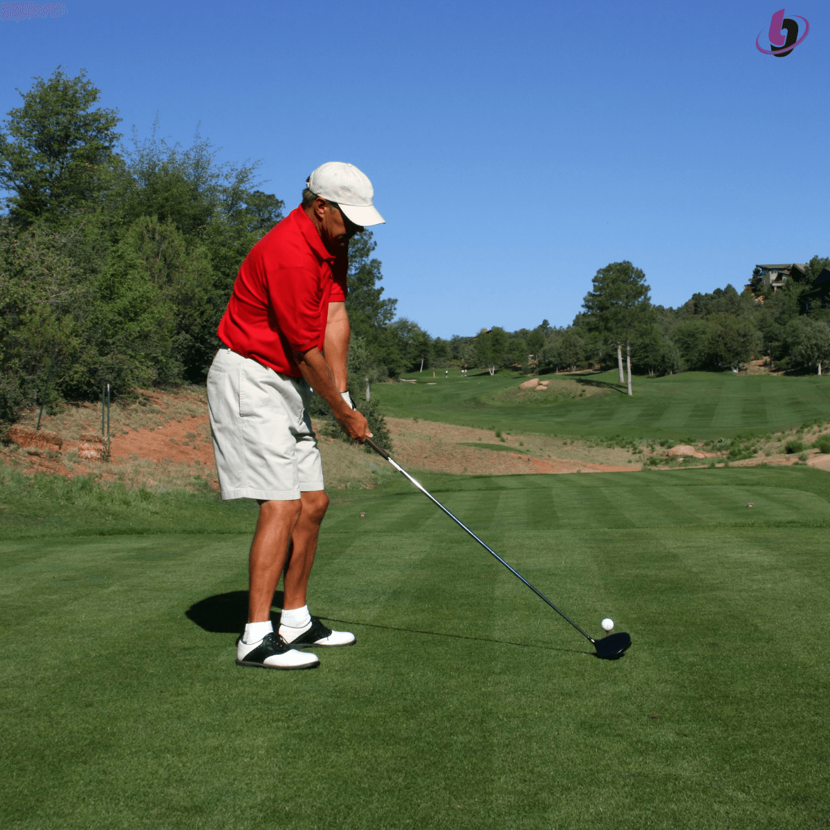 Middle Aged Golfer addressing the golf ball Middle Aged Golfer addressing the golf ball
